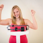 Happy woman on scale